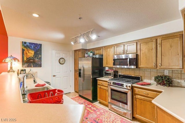 8777 Maule Ave Unit 3116, Las Vegas, NV 89148 - kitchen featuring appliances with stainless steel finishes, a sink, light countertops, and decorative backsplash