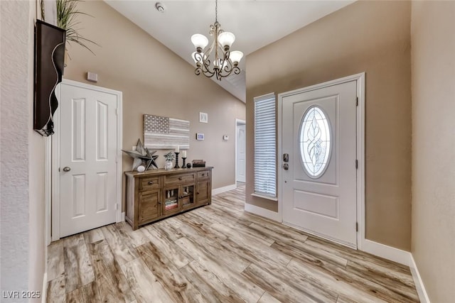 7670 Descanso Ln, Las Vegas, NV 89123 - entrance foyer featuring a chandelier, light wood-style flooring, and high vaulted ceiling
