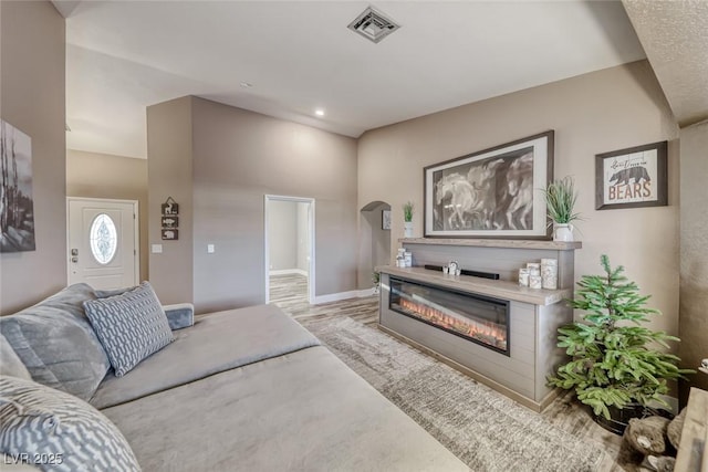 7670 Descanso Ln, Las Vegas, NV 89123 - living area featuring a glass covered fireplace, wood finished floors, and recessed lighting