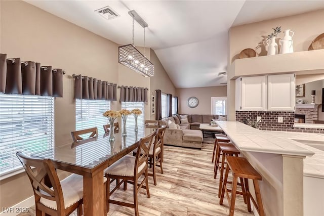 7670 Descanso Ln, Las Vegas, NV 89123 - dining room with light wood-style floors and lofted ceiling
