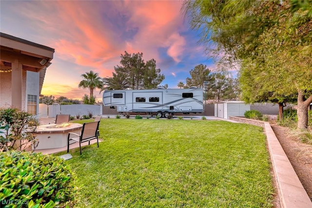 7670 Descanso Ln, Las Vegas, NV 89123 - yard at dusk with a shed and a fire pit