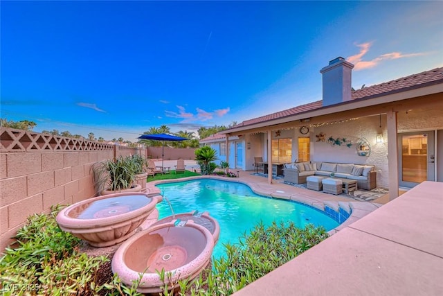 7670 Descanso Ln, Las Vegas, NV 89123 - pool at dusk featuring an outdoor living space, a patio area, a fenced backyard, and a pool with connected hot tub