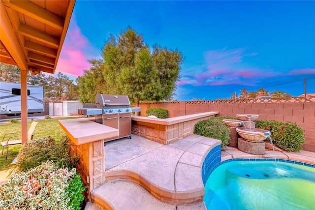 7670 Descanso Ln, Las Vegas, NV 89123 - pool at dusk with a storage unit, a patio, and a grill