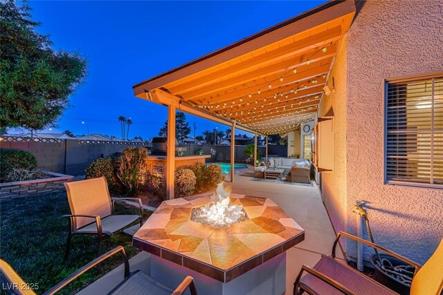 7670 Descanso Ln, Las Vegas, NV 89123 - fenced backyard featuring an outdoor living space with a fire pit and a patio area