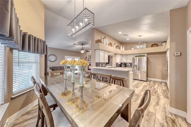 7670 Descanso Ln, Las Vegas, NV 89123 - dining area with a chandelier, a ceiling fan, and light wood-type flooring