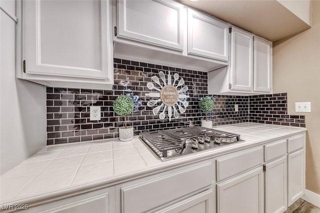 7670 Descanso Ln, Las Vegas, NV 89123 - kitchen with tile countertops, stainless steel gas cooktop, and white cabinets