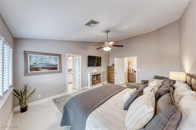 7670 Descanso Ln, Las Vegas, NV 89123 - bedroom featuring lofted ceiling, ensuite bathroom, a glass covered fireplace, and ceiling fan