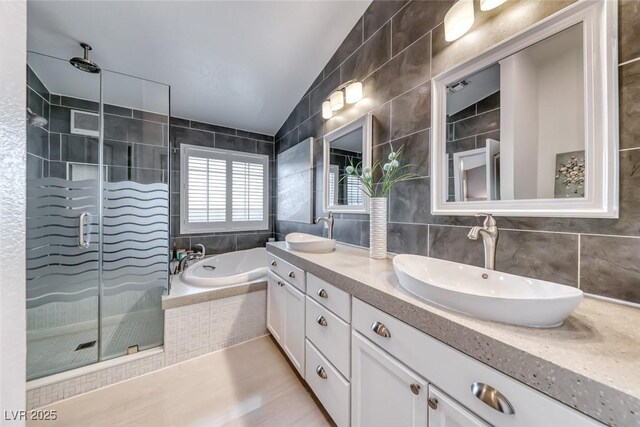 7670 Descanso Ln, Las Vegas, NV 89123 - full bath featuring double vanity, a garden tub, a stall shower, tile walls, and backsplash