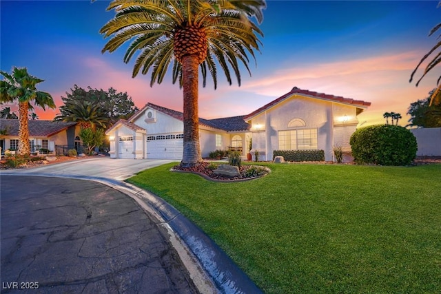 7670 Descanso Ln, Las Vegas, NV 89123 - mediterranean / spanish-style home with a garage, driveway, a front lawn, stucco siding, and a tiled roof