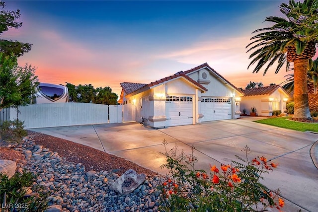 7670 Descanso Ln, Las Vegas, NV 89123 - view of front facade featuring a tile roof, a gate, driveway, an attached garage, and stucco siding