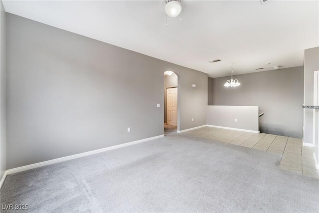 9303 Gilcrease Ave Unit 1013, Las Vegas, NV 89149 - carpeted spare room with arched walkways, baseboards, and a chandelier
