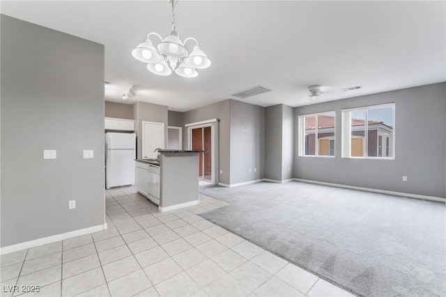 9303 Gilcrease Ave Unit 1013, Las Vegas, NV 89149 - unfurnished living room with baseboards, a chandelier, light colored carpet, and light tile patterned floors