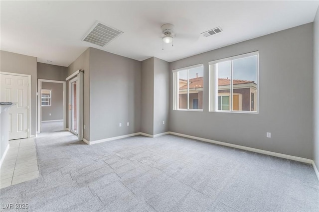 9303 Gilcrease Ave Unit 1013, Las Vegas, NV 89149 - unfurnished room with light colored carpet, a ceiling fan, and baseboards