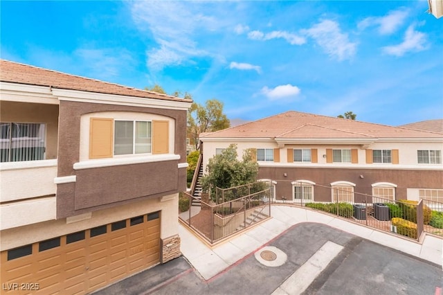 9303 Gilcrease Ave Unit 1013, Las Vegas, NV 89149 - view of front of house with central AC unit and stucco siding