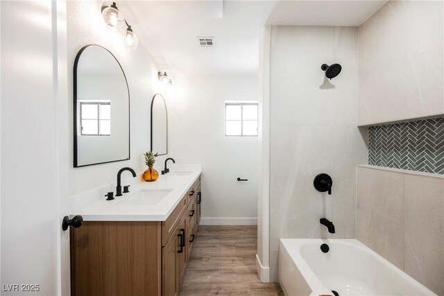 1917 N Moapa Valley Blvd, Logandale, NV 89021 - bathroom featuring shower / bath combination, double vanity, healthy amount of natural light, and wood finished floors