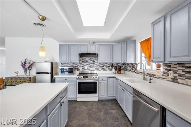 1589 Silver Mesa Way, Las Vegas, NV 89169 - kitchen with stainless steel appliances, gray cabinetry, a sink, and tasteful backsplash