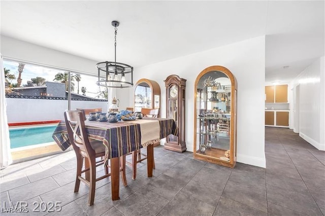 1589 Silver Mesa Way, Las Vegas, NV 89169 - tiled dining room with baseboards and a chandelier