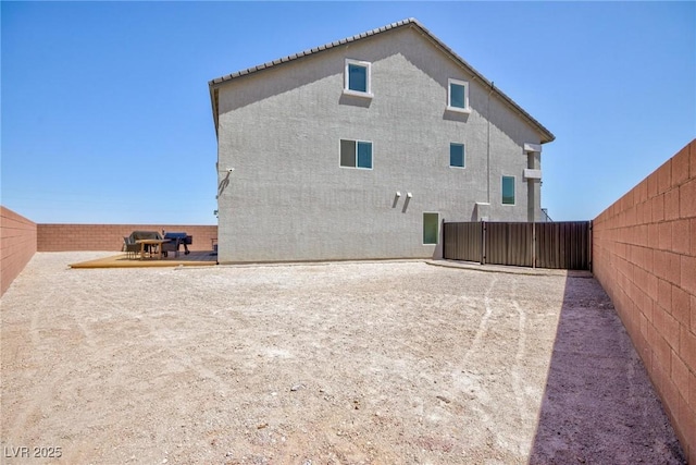 7828 Bright Lodge St, Las Vegas, NV 89139 - rear view of house with a fenced backyard and stucco siding