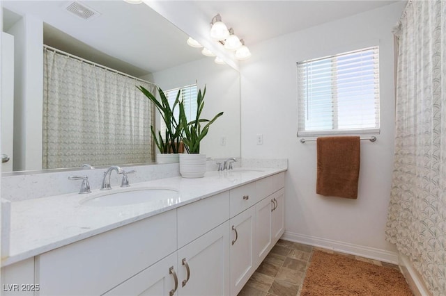7828 Bright Lodge St, Las Vegas, NV 89139 - bathroom featuring double vanity, baseboards, and curtained shower