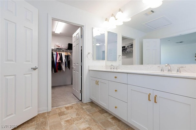 7828 Bright Lodge St, Las Vegas, NV 89139 - full bathroom featuring double vanity, a walk in closet, and stone finish flooring