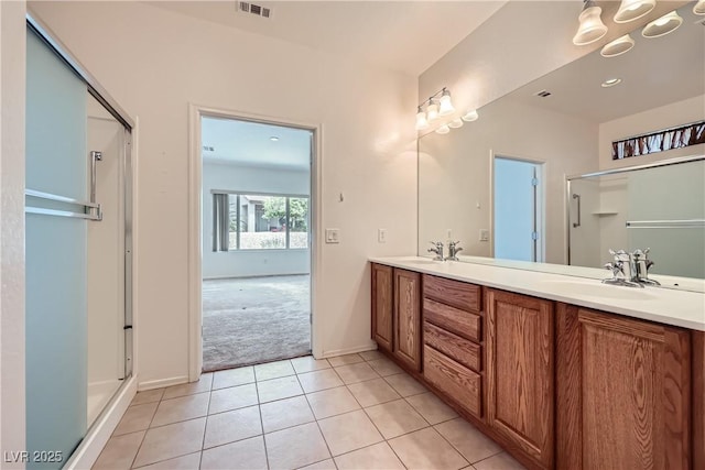 7465 Widewing Dr, North Las Vegas, NV 89084 - bathroom featuring double vanity, a shower stall, tile patterned flooring, and baseboards