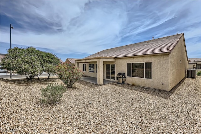 7465 Widewing Dr, North Las Vegas, NV 89084 - back of house featuring stucco siding, a tile roof, a patio, and central AC unit