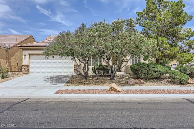 7465 Widewing Dr, North Las Vegas, NV 89084 - obstructed view of property featuring a garage, stucco siding, concrete driveway, and a tiled roof