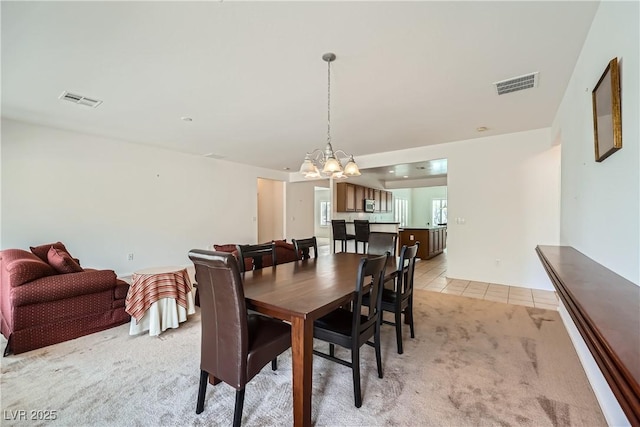 7465 Widewing Dr, North Las Vegas, NV 89084 - dining space featuring a chandelier, light carpet, and light tile patterned flooring