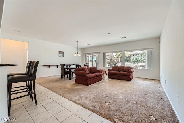 7465 Widewing Dr, North Las Vegas, NV 89084 - living area featuring light colored carpet, light tile patterned floors, and baseboards