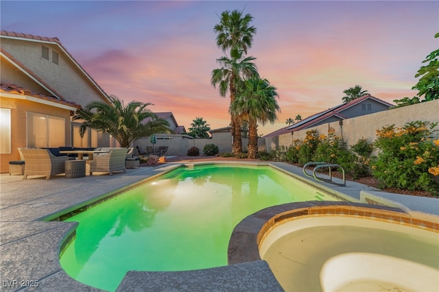5350 Sharon Marie Ct, Las Vegas, NV 89118 - pool at dusk with a patio, a fenced backyard, an outdoor hangout area, and a pool with connected hot tub