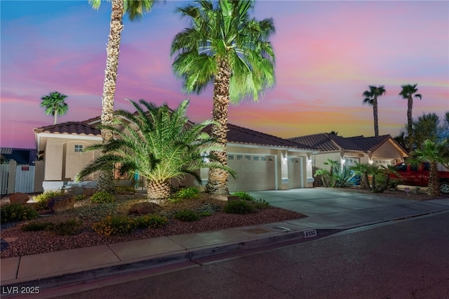 5350 Sharon Marie Ct, Las Vegas, NV 89118 - mediterranean / spanish home with a tile roof, a garage, driveway, and stucco siding