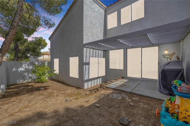 3481 Creek River Dr, Las Vegas, NV 89129 - view of side of home featuring stucco siding and a patio