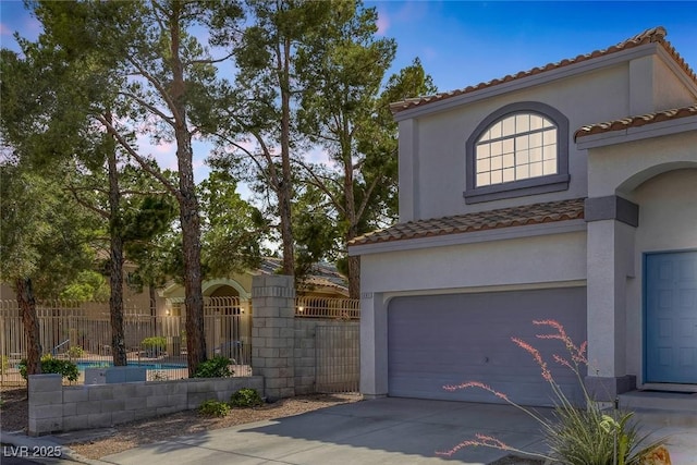3481 Creek River Dr, Las Vegas, NV 89129 - mediterranean / spanish house featuring stucco siding, an attached garage, and concrete driveway