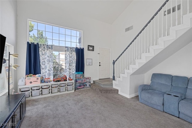 3481 Creek River Dr, Las Vegas, NV 89129 - foyer with high vaulted ceiling, carpet flooring, stairway, healthy amount of natural light, and baseboards