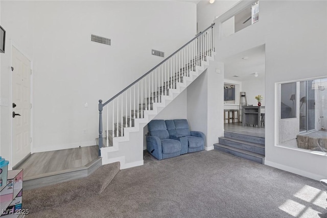 3481 Creek River Dr, Las Vegas, NV 89129 - foyer featuring a high ceiling, stairway, carpet floors, and baseboards