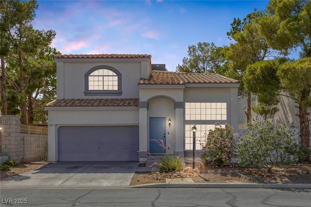 3481 Creek River Dr, Las Vegas, NV 89129 - mediterranean / spanish house with concrete driveway, stucco siding, a tile roof, and a garage