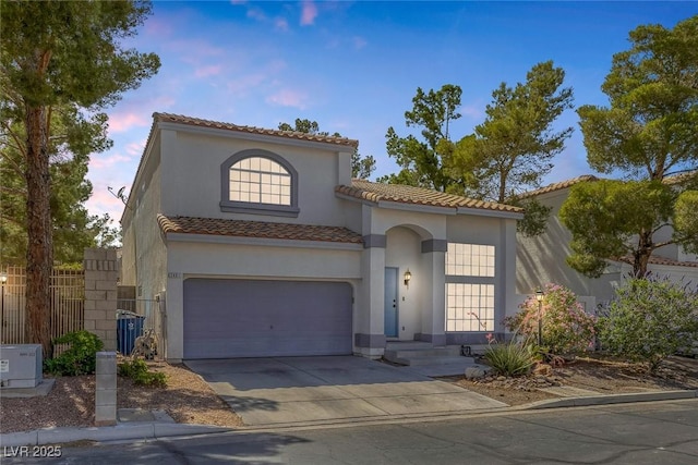 3481 Creek River Dr, Las Vegas, NV 89129 - mediterranean / spanish home with a tile roof, concrete driveway, stucco siding, and a garage