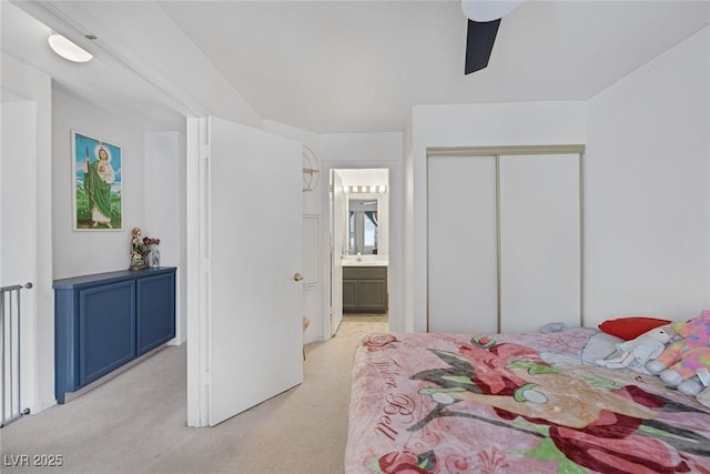 3481 Creek River Dr, Las Vegas, NV 89129 - bedroom with light colored carpet, a closet, ensuite bath, and ceiling fan