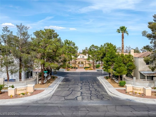 3481 Creek River Dr, Las Vegas, NV 89129 - view of asphalt road featuring sidewalks, curbs, and traffic signs