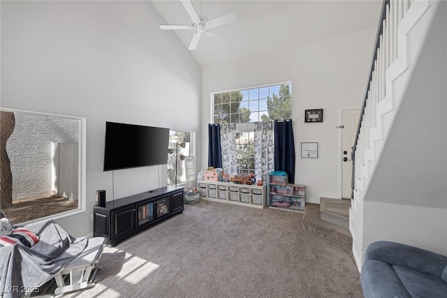 3481 Creek River Dr, Las Vegas, NV 89129 - carpeted living area with high vaulted ceiling, stairs, and ceiling fan