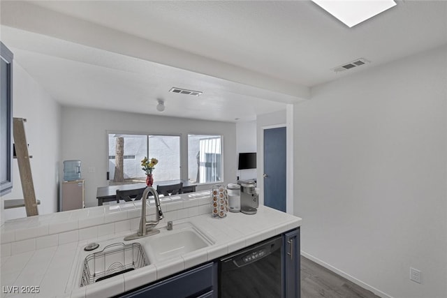3481 Creek River Dr, Las Vegas, NV 89129 - kitchen featuring dishwasher, tile countertops, dark wood finished floors, a sink, and baseboards