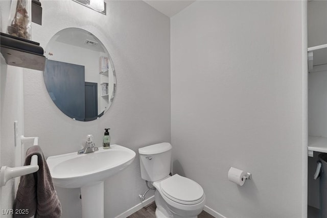 3481 Creek River Dr, Las Vegas, NV 89129 - half bath with toilet, wood finished floors, and baseboards