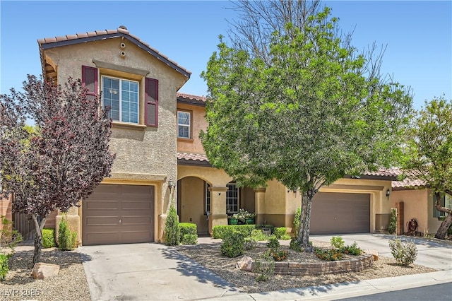 9192 Moose Country Pl, Las Vegas, NV 89178 - mediterranean / spanish-style home with a tiled roof, concrete driveway, stucco siding, and a garage