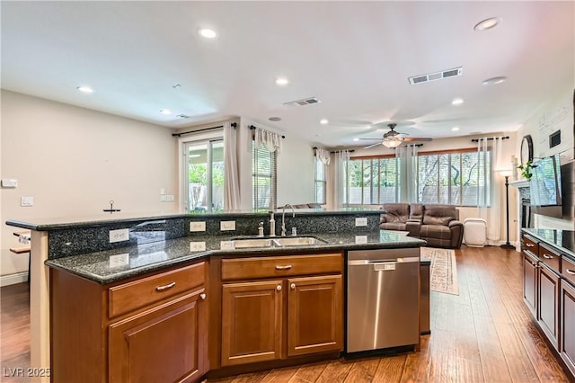 9192 Moose Country Pl, Las Vegas, NV 89178 - kitchen featuring stainless steel dishwasher, a sink, an island with sink, plenty of natural light, and recessed lighting
