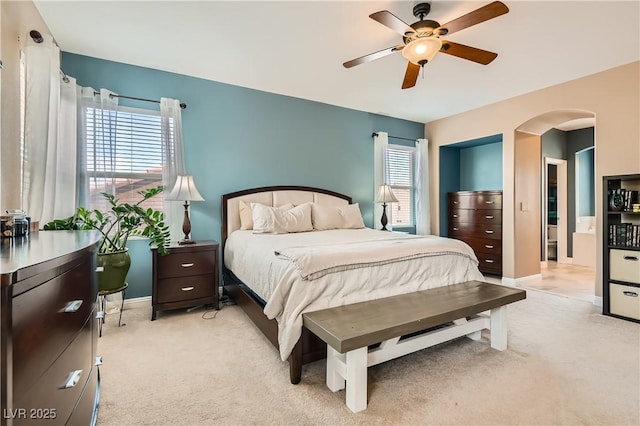 9192 Moose Country Pl, Las Vegas, NV 89178 - bedroom featuring arched walkways, light carpet, and ceiling fan