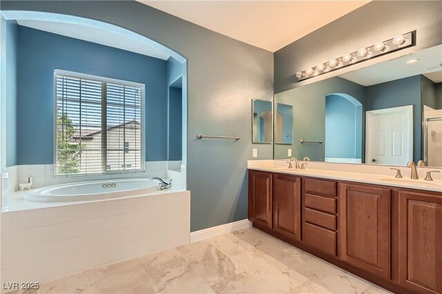9192 Moose Country Pl, Las Vegas, NV 89178 - bathroom featuring a garden tub, marble look tile flooring, double vanity, and a shower with door