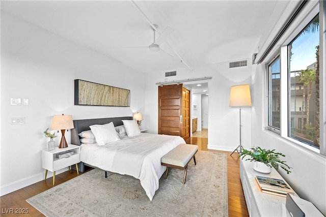 11441 Allerton Park Dr Unit 212, Las Vegas, NV 89135 - bedroom featuring wood finished floors, ceiling fan, and baseboards