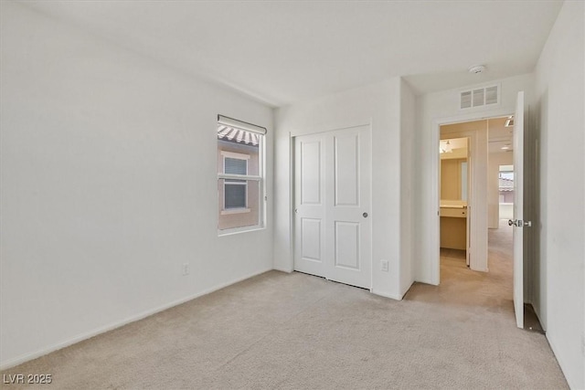 8755 Spanish Ridge Ave, Las Vegas, NV 89148 - unfurnished bedroom featuring light colored carpet, a closet, and baseboards