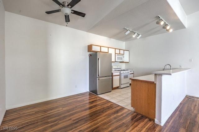 4960 Harrison Dr Unit 214, Las Vegas, NV 89120 - kitchen with white appliances, a peninsula, track lighting, light wood-style flooring, and ceiling fan