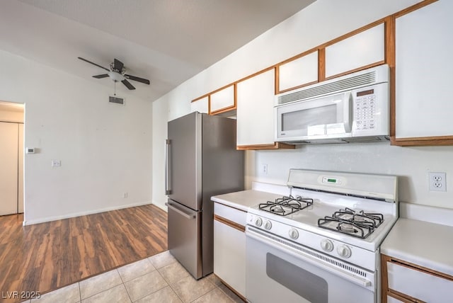 4960 Harrison Dr Unit 214, Las Vegas, NV 89120 - kitchen with white appliances, light countertops, a ceiling fan, and light tile patterned flooring